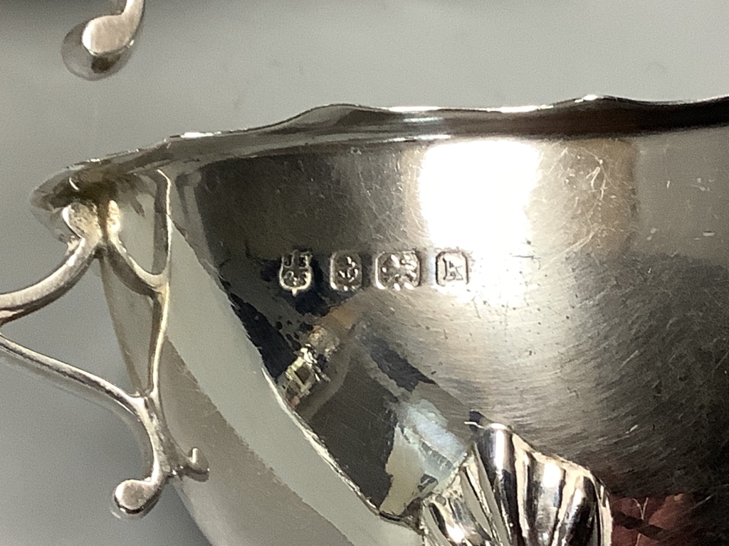 A Britannia silver Christening mug, Sheffield 1931, a pair of silver cream boats, Birmingham 1909 and a small silver sugar bowl approximately 14.6oz